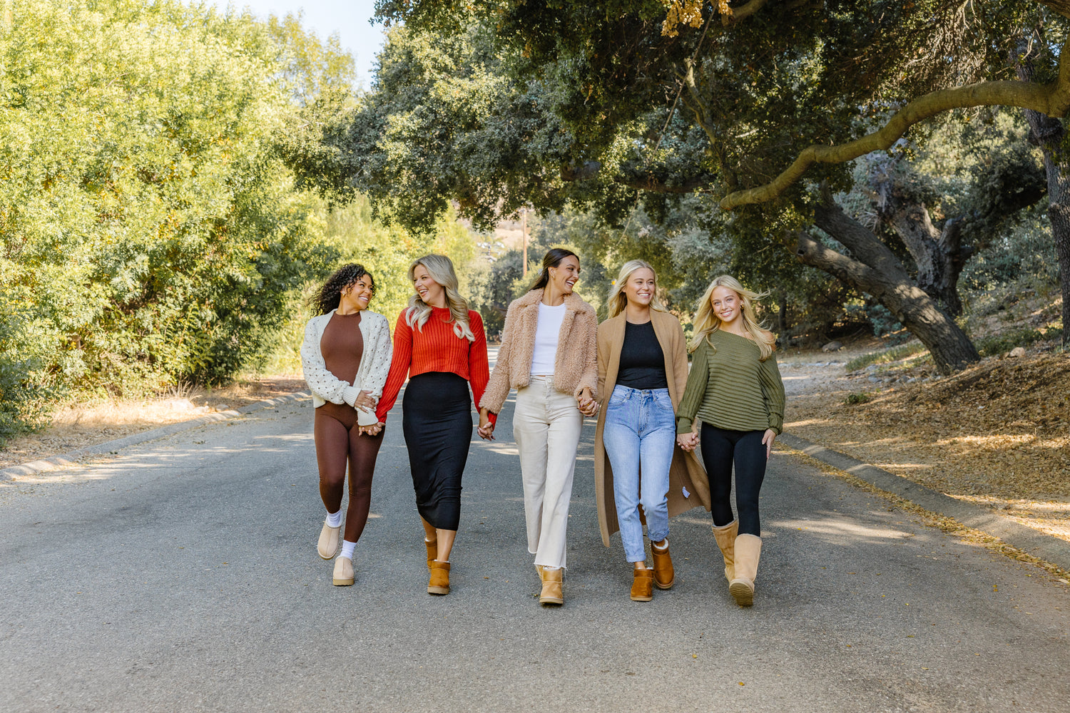 Group of women walking down street with oak trees wearing PAWJ cruelty-free boots