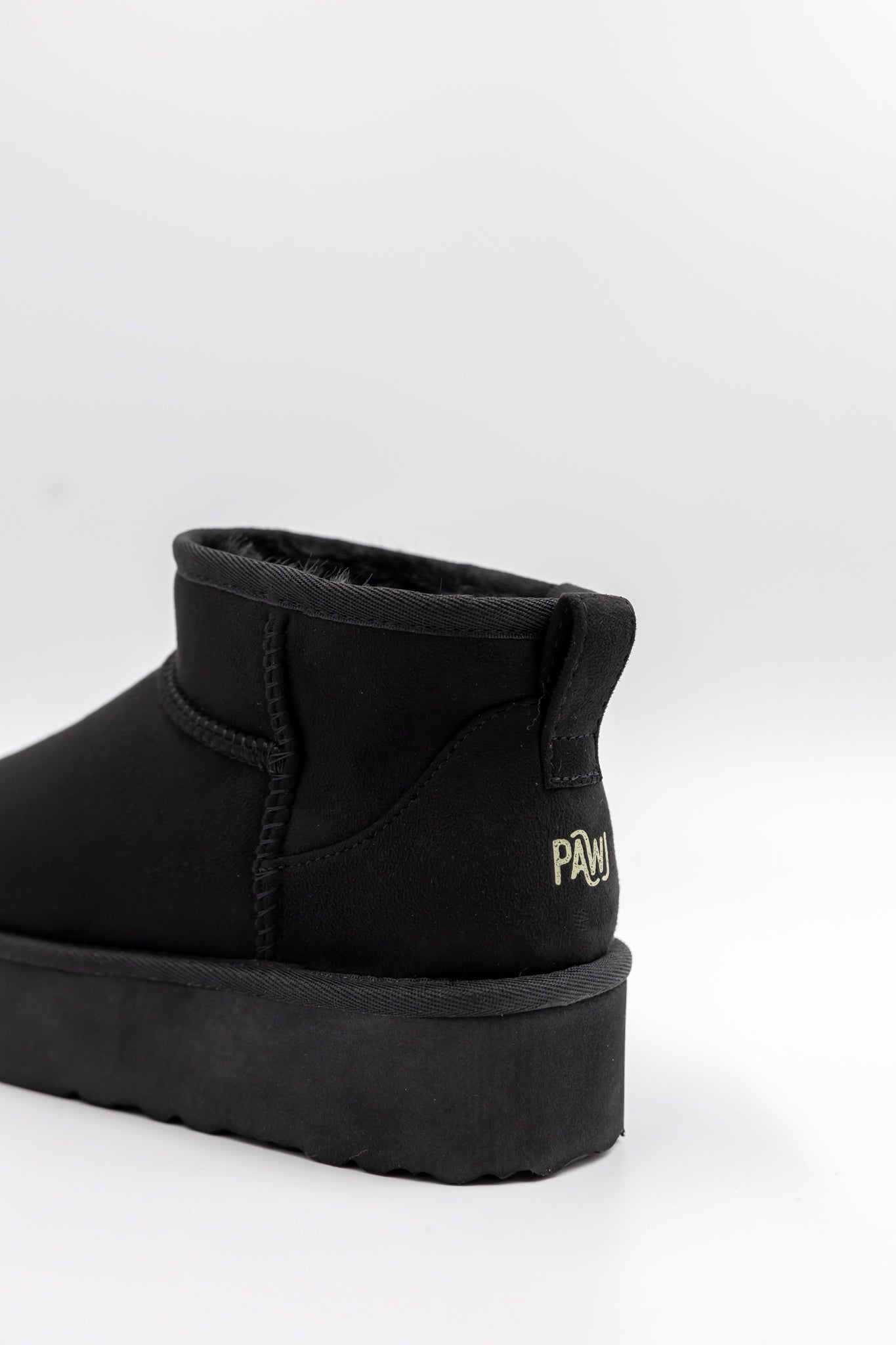 Black ankle boot with visible brand logo on a white background