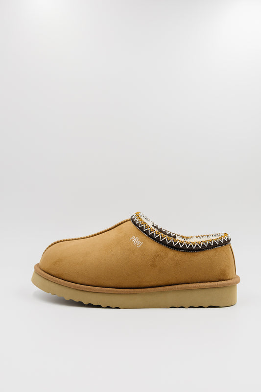 A single men's synthetic suede clog with a decorative black, white, and gold zigzag trim around the collar, shown from a side profile on a light gray background.