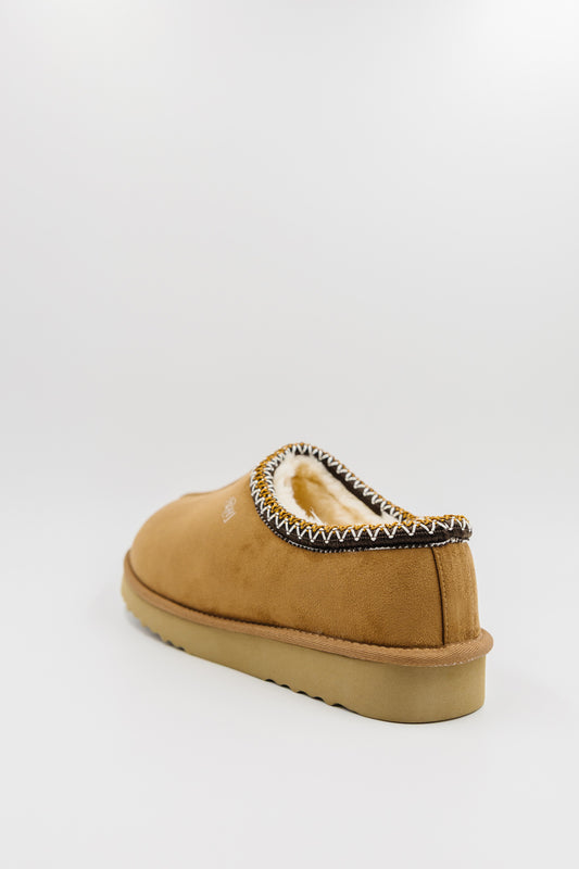 A single men's synthetic suede clog with a decorative black, white, and gold zigzag trim around the collar, shown from a rear three-quarter view on a light gray background.