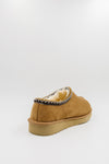 A single men's synthetic suede clog with a decorative black, white, and gold zigzag trim around the collar shown from a rear three-quarter angle on a light gray background.
