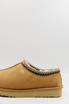 A single men's synthetic suede clog with a decorative black, white, and gold zigzag trim around the collar, shown from a side profile on a light gray background.