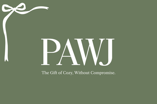 PAWJ gift card with green background and white ribbon with logo and "The gift of cozy, without compromise."